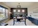 Well-lit home office with modern desk, comfortable chair, and ample storage space and a large window at 4163 Ironclad Dr, Bargersville, IN 46106