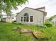 Lush backyard with garden beds and vinyl siding home exterior at 4382 Castlebay Way, Indianapolis, IN 46254