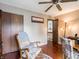Comfortable room featuring a ceiling fan, wood floors, and a rocking chair at 4382 Castlebay Way, Indianapolis, IN 46254