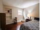 A well-lit bedroom with hardwood floors, with shelving and cat tree at 4382 Castlebay Way, Indianapolis, IN 46254