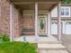 Covered front porch with brick columns and bench seating by front door at 4382 Castlebay Way, Indianapolis, IN 46254