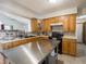 Well-lit kitchen featuring stainless steel island and mosaic tile backsplash at 4382 Castlebay Way, Indianapolis, IN 46254