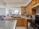Open kitchen with wooden cabinets, stainless appliances, and mosaic backsplash at 4382 Castlebay Way, Indianapolis, IN 46254