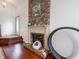 Living room featuring a brick fireplace and hardwood flooring at 4382 Castlebay Way, Indianapolis, IN 46254
