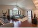 Vaulted ceiling living room with large windows and hardwood floors at 4382 Castlebay Way, Indianapolis, IN 46254