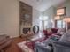 Cozy living room with fireplace, hardwood floors, and comfortable seating at 4382 Castlebay Way, Indianapolis, IN 46254