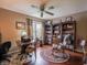 Comfortable home office with a desk, rocking chair, ceiling fan, and hardwood flooring at 4382 Castlebay Way, Indianapolis, IN 46254