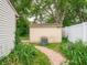 Exterior shot of the home's shed surrounded by garden beds at 4382 Castlebay Way, Indianapolis, IN 46254