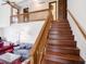 Elegant wood staircase leading to the second floor with a view of the living area at 4382 Castlebay Way, Indianapolis, IN 46254