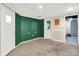 An unfinished basement featuring sealed concrete floors and two doors painted in green at 4641 Crittenden Ave, Indianapolis, IN 46205