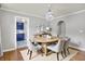 Dining room features hardwood floors, modern chandelier, and arched doorway to kitchen at 4641 Crittenden Ave, Indianapolis, IN 46205