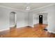 Bright living room featuring hardwood floors, arched doorways, and a modern light fixture at 4641 Crittenden Ave, Indianapolis, IN 46205