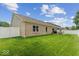Spacious backyard featuring lush green grass, white fence, and privacy at 4736 Blue Marlin Way, Indianapolis, IN 46239