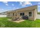 Brick house with backyard featuring patio seating and well-maintained lawn at 4736 Blue Marlin Way, Indianapolis, IN 46239