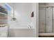 Bright bathtub area with shower and built-in shelves for storage; perfect for relaxation at 4736 Blue Marlin Way, Indianapolis, IN 46239