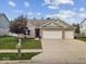 Charming brick home featuring a well-maintained lawn and two-car garage, perfect for suburban living at 4736 Blue Marlin Way, Indianapolis, IN 46239