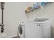 Well-equipped laundry room featuring modern washer, dryer, and ample storage shelves at 4736 Blue Marlin Way, Indianapolis, IN 46239