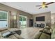 Cozy living room with hardwood floors, a large sectional sofa, and access to an outdoor space at 4736 Blue Marlin Way, Indianapolis, IN 46239