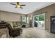 Inviting living room featuring hardwood floors, comfortable seating, and a sliding glass door to the outside at 4736 Blue Marlin Way, Indianapolis, IN 46239