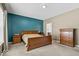 Cozy main bedroom featuring a stylish accent wall, wood furniture, and a neutral color palette at 4736 Blue Marlin Way, Indianapolis, IN 46239