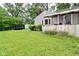 Spacious backyard with green lawn, wood fence and a detached garage at 4751 N Longworth Ave, Indianapolis, IN 46226
