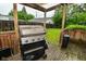 Cozy backyard features a wooden deck with a grill, perfect for outdoor dining and entertaining at 4751 N Longworth Ave, Indianapolis, IN 46226