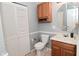 Bathroom featuring a oak vanity, a toilet, and a closet at 4751 N Longworth Ave, Indianapolis, IN 46226