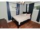 Bedroom with hard wood flooring, queen bed and natural light at 4751 N Longworth Ave, Indianapolis, IN 46226