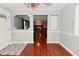 Open-concept dining area with hardwood floors and views into multiple living spaces and the front door at 4751 N Longworth Ave, Indianapolis, IN 46226