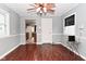 Hardwood floor dining space with ceiling fan, view to kitchen, and lots of light at 4751 N Longworth Ave, Indianapolis, IN 46226