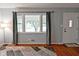 Inviting entryway with hardwood floors, large window, and charming front door, offering curb appeal at 4751 N Longworth Ave, Indianapolis, IN 46226