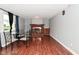 Cozy living room with hardwood floors, brick fireplace and large window at 4751 N Longworth Ave, Indianapolis, IN 46226