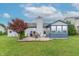 Lush backyard with a patio, red maple tree, and an enclosed sunroom at 488 Village Blvd, Mooresville, IN 46158