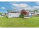 Large backyard features a well-maintained lawn, patio area, and sunroom addition at 488 Village Blvd, Mooresville, IN 46158