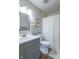 Updated bathroom boasts modern vanity, framed mirror, and shower with curtain at 488 Village Blvd, Mooresville, IN 46158