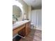 Bathroom with modern vanity, round mirror, and shower with curtain at 488 Village Blvd, Mooresville, IN 46158