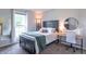 Bright bedroom with natural light, modern decor, and view of the outdoors at 488 Village Blvd, Mooresville, IN 46158