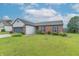 Well-maintained home with a manicured lawn and blue shutters enhancing the curb appeal at 488 Village Blvd, Mooresville, IN 46158