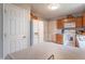 Well-lit kitchen with wood cabinets, white appliances, and neutral countertops at 488 Village Blvd, Mooresville, IN 46158
