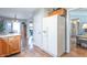 Bright kitchen featuring wooden cabinets, hardwood flooring, and stainless-steel refrigerator at 488 Village Blvd, Mooresville, IN 46158