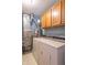Utility area features laundry machines and adjacent storage cabinet space at 488 Village Blvd, Mooresville, IN 46158