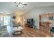 Spacious living room featuring a vaulted ceiling, wood floors, and a seamless transition to the dining area at 488 Village Blvd, Mooresville, IN 46158