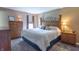 Comfortable main bedroom with wood furnishings, soft carpet, and natural light at 488 Village Blvd, Mooresville, IN 46158