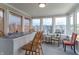 Inviting sunroom with multiple windows and seating, filled with sunlight at 488 Village Blvd, Mooresville, IN 46158
