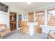 Bright sunroom with bar area, wood stools, and lots of natural light at 488 Village Blvd, Mooresville, IN 46158