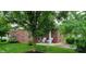 Brick home exterior featuring a cozy back porch and well-maintained backyard at 5189 Bally Bunion Dr, Avon, IN 46123