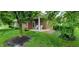 Quaint back porch with white chairs, lovely landscaping and a peaceful outdoor setting at 5189 Bally Bunion Dr, Avon, IN 46123
