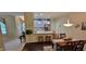 Dining area featuring hardwood floors, pendant lighting, and a counter-height breakfast bar overlooking kitchen at 5189 Bally Bunion Dr, Avon, IN 46123