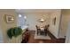 Open dining room with hardwood floors, a stylish light fixture, and adjacent kitchen area for easy entertaining at 5189 Bally Bunion Dr, Avon, IN 46123
