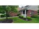 Charming front of brick house with trimmed bushes, mulch bed and covered porch area at 5189 Bally Bunion Dr, Avon, IN 46123